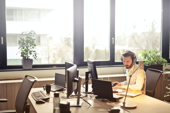 man at the office with headphones